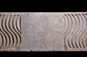 Paleochretian art: fragmentary sarcophagus tank: Good Shepherd and epitaph of Livia Primitiva. A shepherd with lambs, a fish (Christian symbol) and an anchor. Find in Rome under St. Peter
