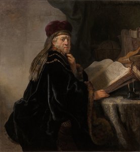 En lærd som sitter ved en pultstipendiat ved studiet av Rembrandt van Rijn
