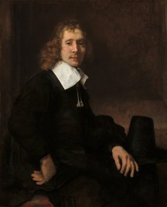 En ung mann som sitter ved et bord (muligens Govaert Flinck) av Rembrandt van Rijn