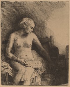Kvinne på badet med en hatt ved siden av henne av Rembrandt van Rijn