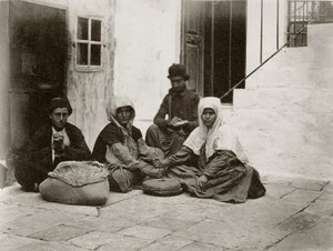 Kvinner maler mel med runde kvernsteiner i en gårdsplass til et hus i Jerusalem, 1867