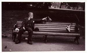 Mann på en parkbenk, ca 1920 Et øyeblikksbilde av en mann som sitter på en parkbenk og mater duer, tatt av en ukjent fotograf i ca. 1920 av Unbekannt