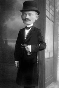 Portrett av en svært elegant mann med et kjempehode. Han har på seg en melonhatt, en stokk, en sløyfe og en svart frakk. Dette er en fotomontasje. Annees 1910 Historisk fotografi, mann med et kjempehode av Unbekannter Künstler