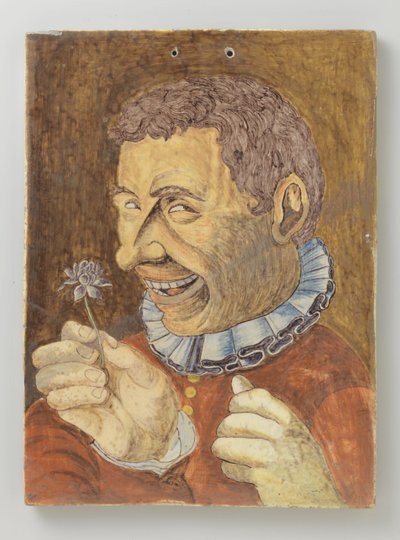 tallerken av fajanse med mann med blomst av Anonymous