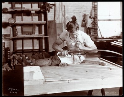 En mann som arbeider i Hartman Piano Co.-fabrikken, 1907 (sølv gelatintrykk) av Byron Company