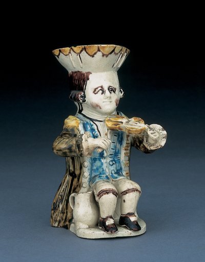 Spillemann toby-mugge, hatten med brun og gul kamkant, brunt hår innskåret og bundet i kø med en hvit rosett, i en vasket brun frakk, ca. 1770 av English School