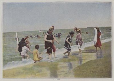 Barn som leker med et tau på stranden (fargebilde) av French Photographer