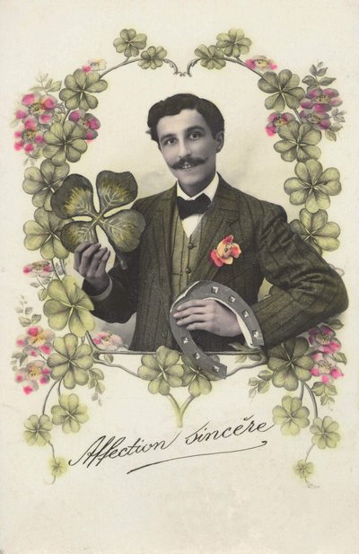 A man with a four-leaf trefle and a horseshoe. av French School