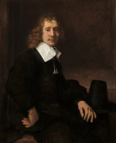 En ung mann som sitter ved et bord (muligens Govaert Flinck) av Rembrandt van Rijn