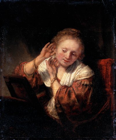 Ung kvinne prøver på øredobber, 1657. av Rembrandt van Rijn