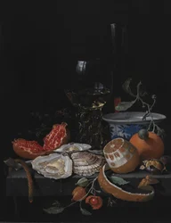 Østers, frukt og et vinglass på et steinbord