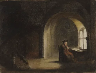 Mann sittende ved et vindu