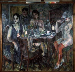 I kunstnerstudioet. Maleren representerte seg selv, røykende en sigarett, omgitt av nakne kvinner, nær et bord med en samovar, flasker vin, glass, kopper og en skål med frukt. En erotisk, tung og smektende atmosfære