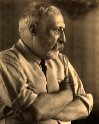 Profilportrett av maleren Arturo Rietti med armene foldet