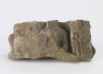 Fragment, som viser overkropp av sittende Buddha, en stående Bodhisattva og to kartusjer på forsiden, ca. 500