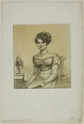 Kvinne sitter foran et bord
