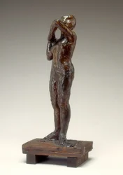 Danser som justerer skulderremmen på kroppen hennes, 1880-1890-tallet.