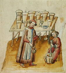 En farmasøyt og hans assistent knuser urter og røtter til medisinsk bruk, ca. 1380–1400