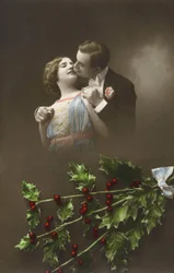A couple in love and holly branches. Postcard early 20th century