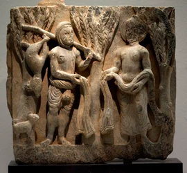 Bytte av klær med en jeger. Skulptert lavrelieff, Gandhara-kunst (Pakistan), 2.-3. århundre. Koreas nasjonalmuseum, Seoul (Sør-Korea).
