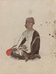 Figur av sittende mann