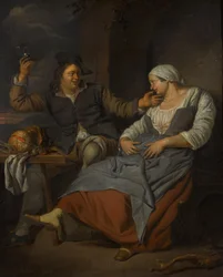 Et sittende par drikker vin