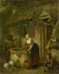 Kvinne som henter vann fra en brønn