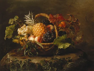 En ananas, druer, fersken og aprikoser i en kurv,