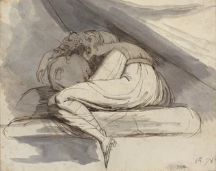Kvinne sitter, krøllet sammen