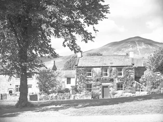 The Stag Inn er bygningen i midten av bildet med hus på hver side.