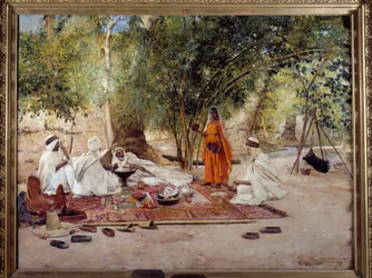 Orientalisme: «Gjestfrihetens måltid». Scene fra arabisk liv i oasen Chelma nær Biskra i Algerie. Maleri av Maurice Bompard (1857-1936), 1891. Marseille, Musée des Beaux-Arts