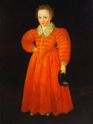 Portrett av en liten gutt, stående i hel figur, iført en rød kjole med en hvit blondekrage, holdende en svart hatt