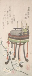 Plommegren med blomster og stativ med skrivesett, 1800-tallet.