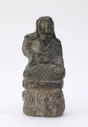 Liten statue av en buddhistisk prest