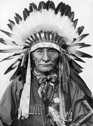 A Native American chief wearing his headdress