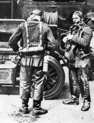 Brannmenn som tar på seg røykhjelmer, Farringdon Street gummiverk, London, 1926-1927