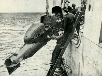 Heising av en vognbemannet torpedo om bord på et skip, andre verdenskrig, 1945.
