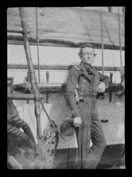 En uidentifisert marineoffiser (?) stående ved naglebenken på babord side av 80-kanoners tredekkeren HMS 